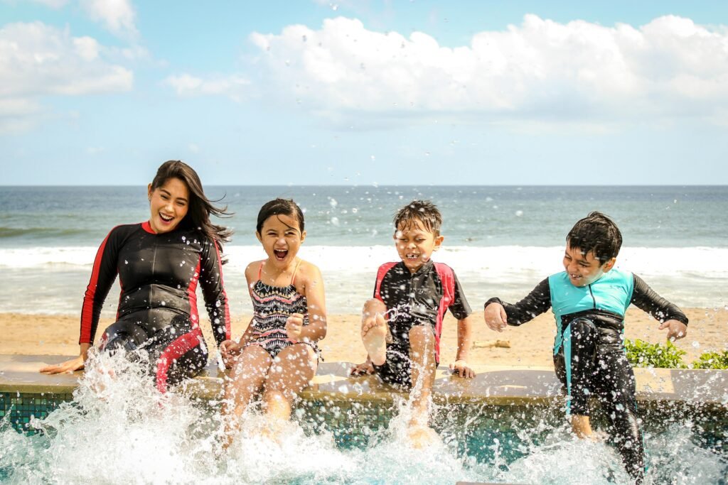 pexels photo 1231365 1231365 A family having fun splashing water near the seashore on a sunny day in Bali, Indonesia.